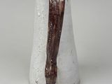 a white vase with a brown handle on it