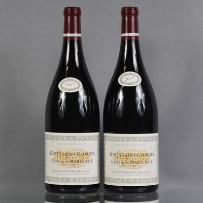 two bottles of red wine sitting on top of a table