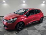 a red car parked in a garage with a checkered floor