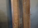 a tall wooden cabinet with a mirror on top of it