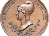 an image of a bronze coin with a woman ' s head on it