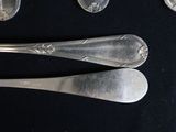 four spoons and two spoons on a black table
