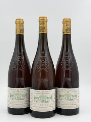 three bottles of wine sitting next to each other on a white surface
