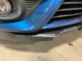 a close up of the front of a blue car