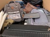 a box full of luggage sitting outside of a building