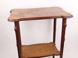 an old wooden table with a shelf on top of it