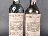 two bottles of wine are sitting next to each other on a table