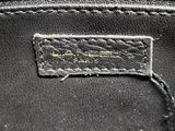 a close up of a black purse with a tag on it