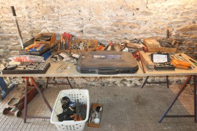 a table with many tools on it in a room