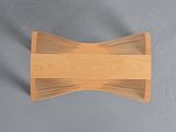 an overhead view of a wooden bench against a gray wall