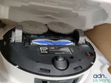 someone is cleaning the top of a dishwasher with a rag