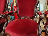 two red chairs that are sitting on a wooden floor