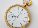 a gold pocket watch with roman numerals on it