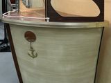 a small boat shaped table with a mirror on top of it