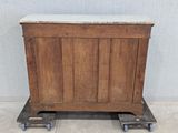 an old wooden chest with a marble top on wheels