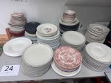a lot of plates and bowls on the table