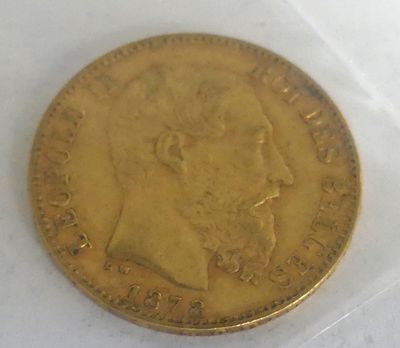 a close up of a gold coin on a white surface