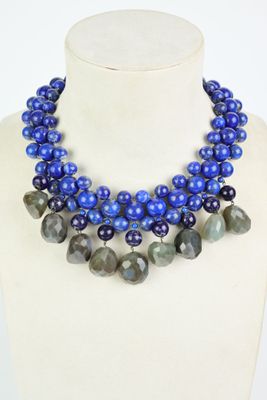 a close up of a necklace on a mannequin with blue beads