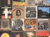 many different album covers on the wall of a room