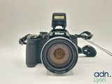 a black camera with a flash light attached to it