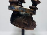 an image of a sculpture of a woman ' s head with three candles on it