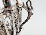 a silver vase with spoons and spoons in it