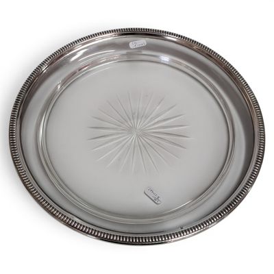 silver plate with a starburst design on the rim