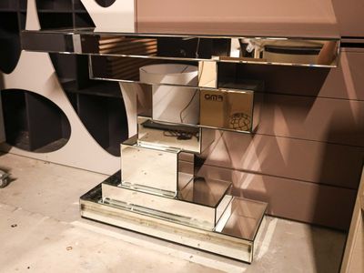 a mirrored desk with a mirror top and a mirror shelf
