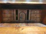 a wooden desk with a mirror on top of it