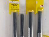 three pens are lined up in a row on a shelf