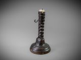 an image of a metal candle holder with two candles on it