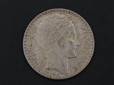 an old silver coin with a woman ' s head and a crown on it