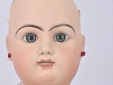 a close up of a doll with a bald head