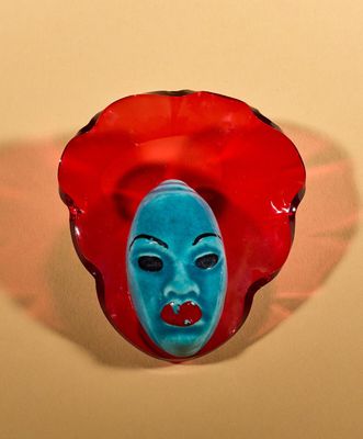 a red and blue mask with a blue face on it