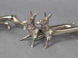 pair of silver deer cufflinks on a grey background