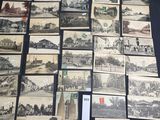 a lot of old black and white pictures on the table