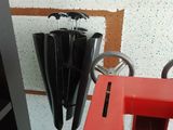 un parapluie noir suspendu au côté d'une chaise rouge