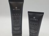 two tubes of black hair products sitting next to each other