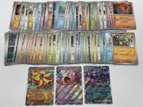 a lot of different pokemon cards on the table