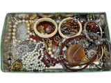 a tray with many different types of jewelry in it