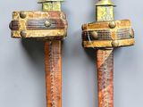 pair of bronze and copper swords with wooden handles
