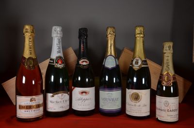 several bottles of wine are lined up on a red table