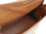 the inside of a brown purse with a zipper open
