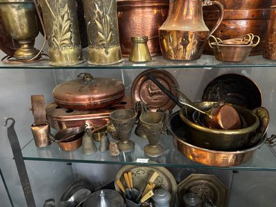 many pots and pans on display in a glass case
