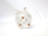 a glass pig toy that is sitting on a white surface