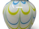 a white vase with a blue and yellow swirl design on it