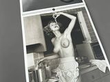 a black and white photo of a naked woman in a kitchen