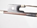 a close up of a violin bow with a piece of wood