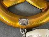 a gold colored pretzel with a chain attached to it