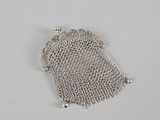 a silver mesh purse with a chain around it